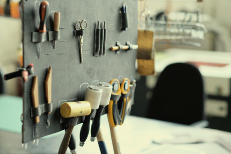 Leather crafting tools in workshopの写真素材