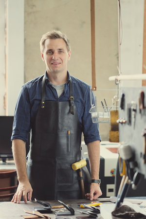 Leather craft workshop owner at his work placeの写真素材