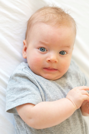 Four months old baby with blue eyesの写真素材