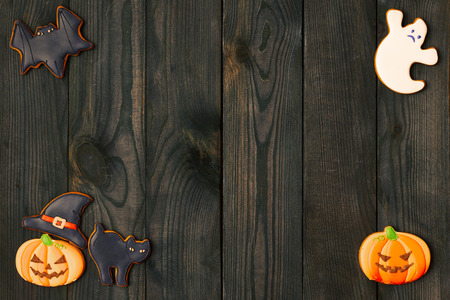 Halloween homemade gingerbread cookies over wooden backgroundの写真素材