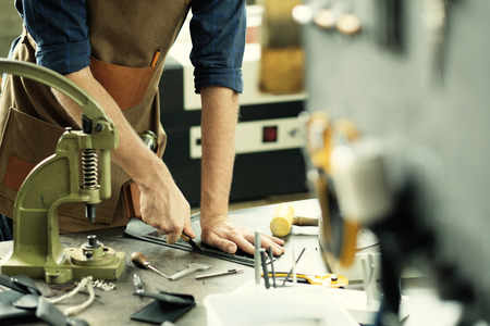 Leather craft workshop owner at his work place