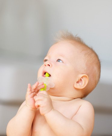 Baby boy with toothbrush portraitの写真素材
