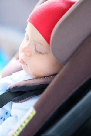 Six months old baby sleeping in car seatの写真素材