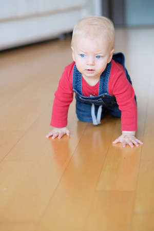 Baby boy crawling on floorの写真素材