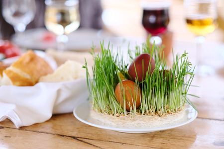 Easter table setting with eggs, wine and decorationの写真素材