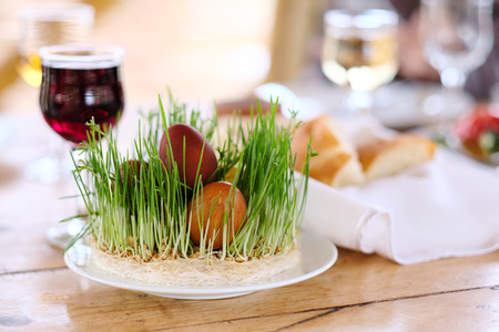 Easter table setting with eggs, wine and decorationの写真素材