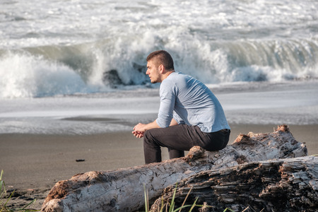 Lone man at beach, autumn. USA Pacific coast landscape, Californiaの写真素材