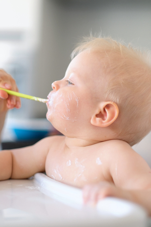 Feeding baby with a spoonの写真素材