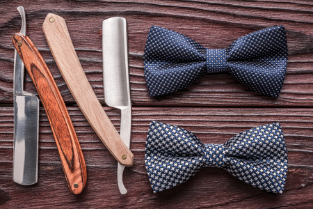 Vintage barber shop straight razor tool on old wooden backgroundの写真素材