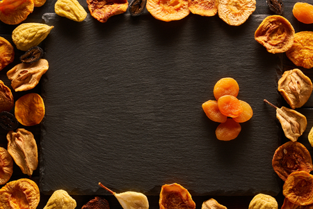Dried fruits on slate plate background の写真素材
