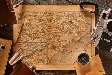 Vintage old 35mm camera on wooden background with antique XIX century mapの写真素材