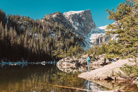 Woman tourist near Dream Lake at autumn in Rocky Mountain National Park. Colorado, USA.の写真素材