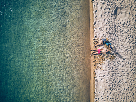 Beautiful beach with family top aerial view drone shot, Sithonia, Greeceの写真素材