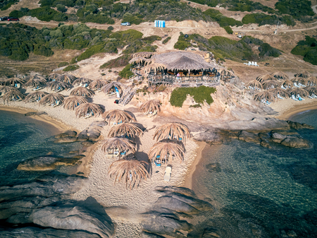 Man in bar on a beautiful beach aerial view drone shot, Sithonia, Greeceの写真素材