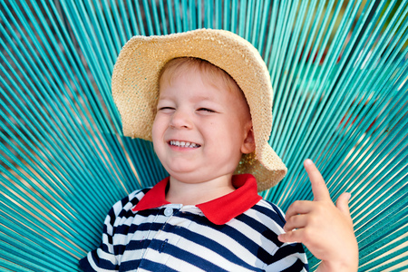 Two year old toddler boy in beach chairの写真素材