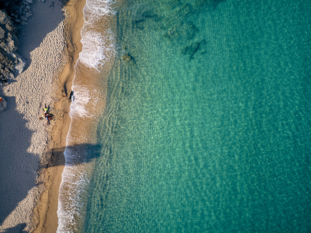 Beautiful beach with family top aerial view drone shot, Sithonia, Greece