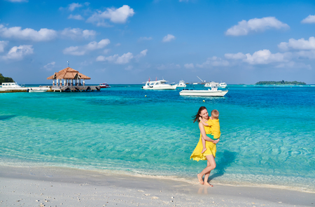 Three year old toddler boy on beach with mother. Summer family vacation at Maldives.の写真素材