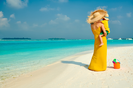 Three year old toddler boy on beach with mother. Summer family vacation at Maldives.の写真素材