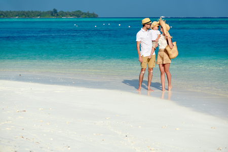 Family on beach, young couple with three year old boy. Summer vacation at Maldives.の写真素材