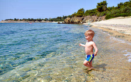 Two year old toddler boy on beachの写真素材