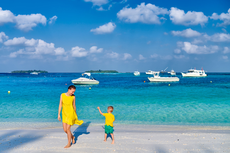Three year old toddler boy on beach with mother. Summer family vacation at Maldives.の写真素材