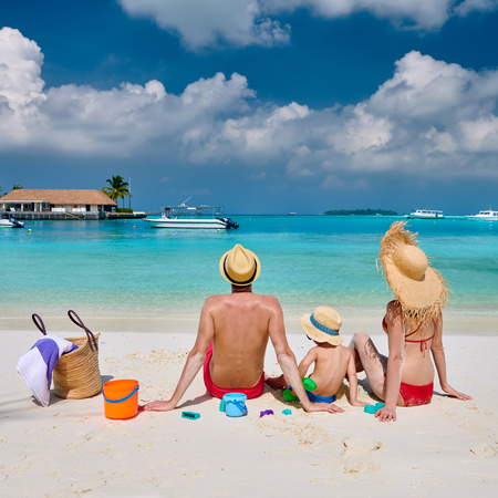 Family on beach, young couple with three year old boy. Summer vacation at Maldives.の写真素材