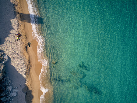 Beautiful beach with family top aerial view drone shot, Sithonia, Greeceの写真素材