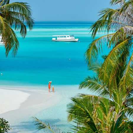 Three year old toddler boy on beach with mother. Summer family vacation at Maldives.の写真素材