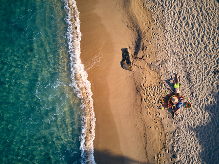Beautiful beach with family top aerial view drone shot, Sithonia, Greeceの写真素材
