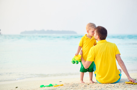 Three year old toddler boy on beach with father. Summer family vacation at Maldives.の写真素材