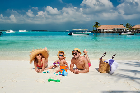 Family on beach, young couple with three year old boy. Summer vacation at Maldives.の写真素材