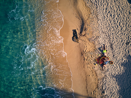 Beautiful beach with family top aerial view drone shot, Sithonia, Greeceの写真素材