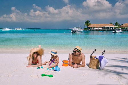 Family on beach, young couple with three year old boy. Summer vacation at Maldives.の写真素材