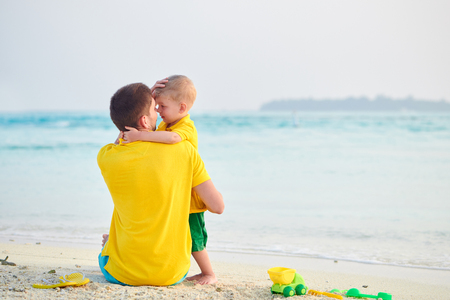 Three year old toddler boy on beach with father. Summer family vacation at Maldives.の写真素材