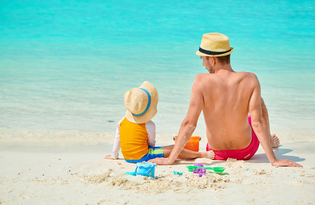 Three year old toddler boy on beach with father. Summer family vacation at Maldives.の写真素材