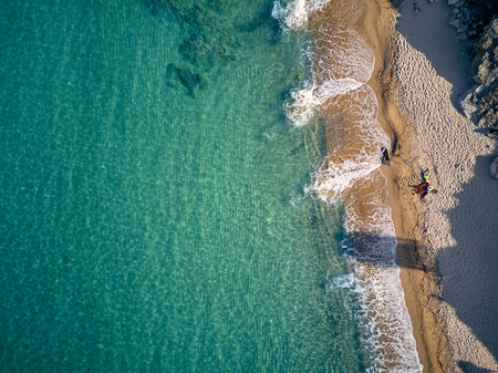 Beautiful beach with family top aerial view drone shot, Sithonia, Greeceの写真素材