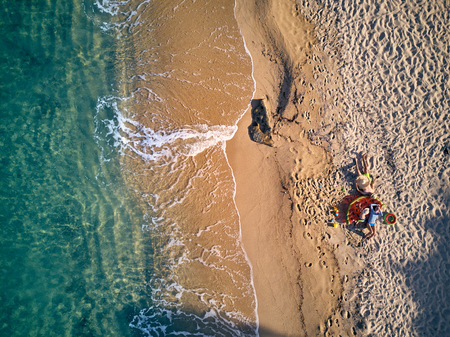 Beautiful beach with family top aerial view drone shot, Sithonia, Greeceの写真素材