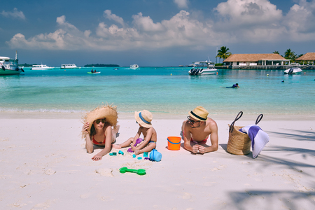 Family on beach, young couple with three year old boy. Summer vacation at Maldives.の写真素材