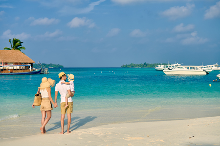 Family on beach, young couple with three year old boy. Summer vacation at Maldives.の写真素材