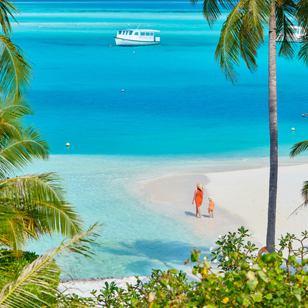 Three year old toddler boy on beach with mother. Summer family vacation at Maldives.の写真素材