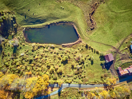 Scenic landscape with farm at autumn in Woodstock, Vermont, USA. Fall in New England. Aerial drone shot.の写真素材
