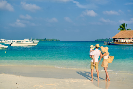 Family on beach, young couple with three year old boy. Summer vacation at Maldives.の写真素材