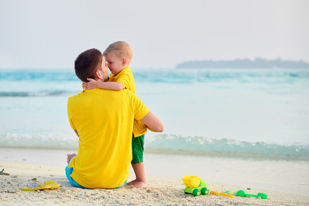 Three year old toddler boy on beach with father. Summer family vacation at Maldives.の写真素材