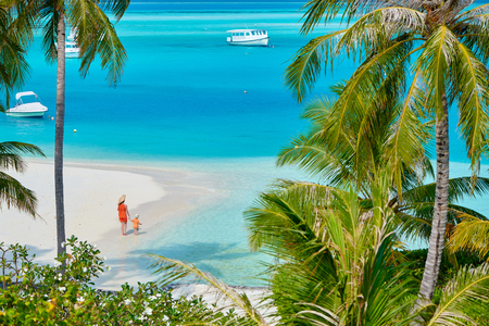 Three year old toddler boy on beach with mother. Summer family vacation at Maldives.の写真素材