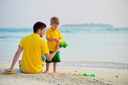 Three year old toddler boy on beach with father. Summer family vacation at Maldives.の写真素材