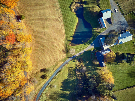 Scenic landscape with farm at autumn in Woodstock, Vermont, USA. Fall in New England. Aerial drone shot.の写真素材