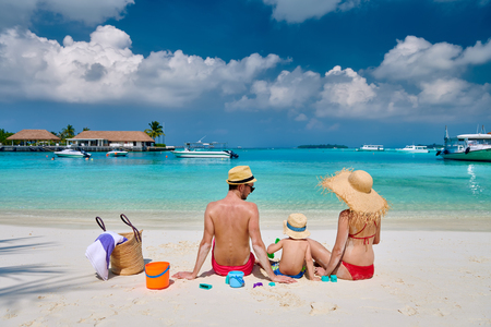 Family on beach, young couple with three year old boy. Summer vacation at Maldives.の写真素材