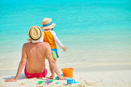 Three year old toddler boy on beach with father. Summer family vacation at Maldives.の写真素材