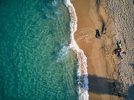 Beautiful beach with family top aerial view drone shot, Sithonia, Greeceの写真素材