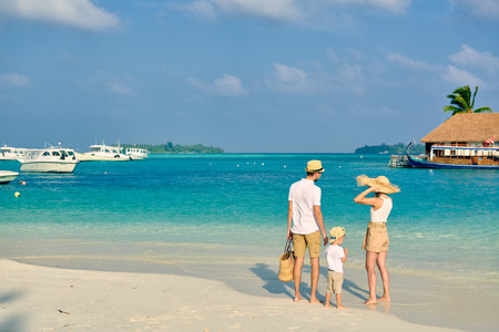 Family on beach, young couple with three year old boy. Summer vacation at Maldives.の写真素材
